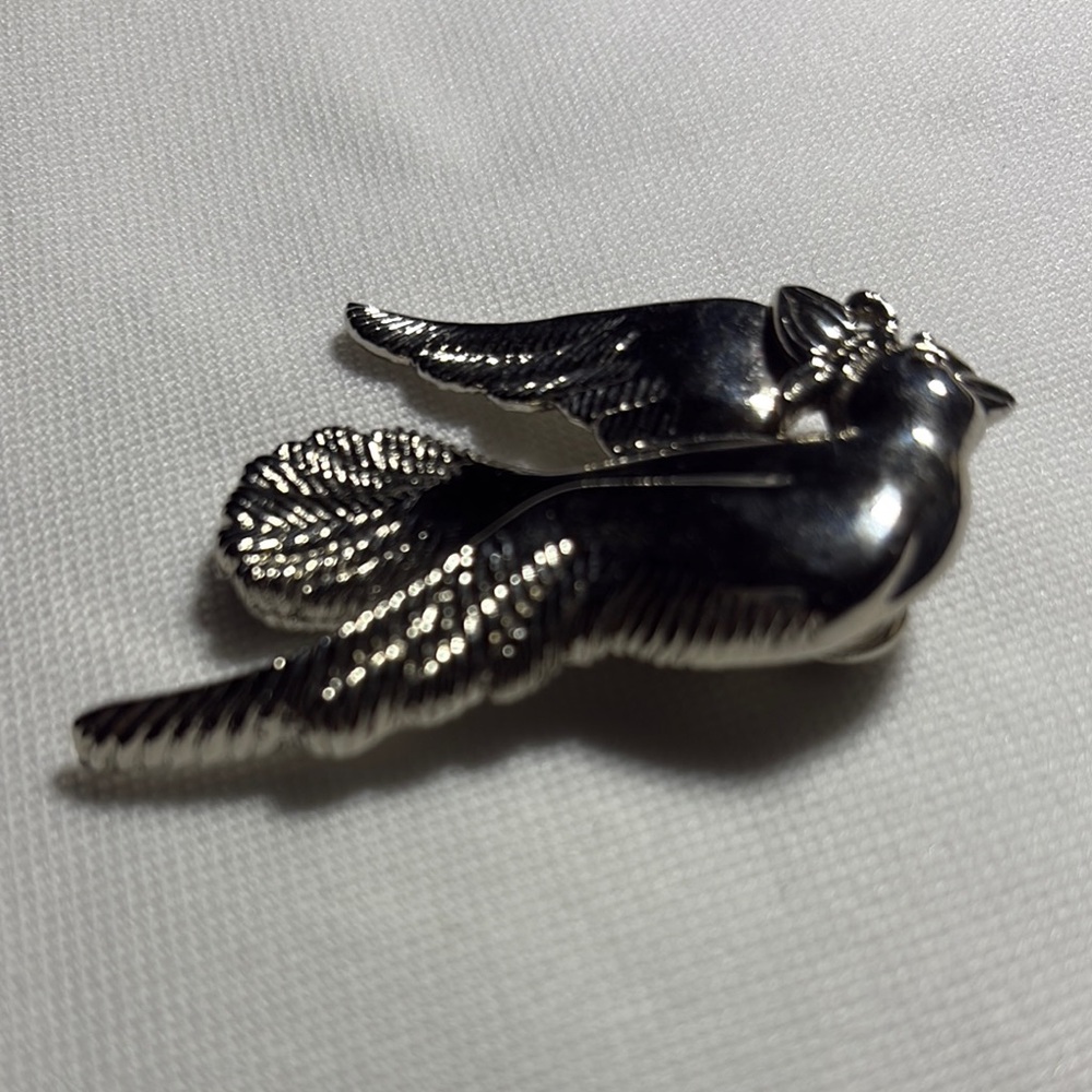 Stylized Silver Bird Pin with Textured Wings